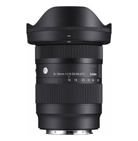 Black camera lens front view with ridged focusing ring and scale numbers