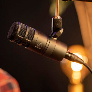 Dynamic microphone on stand with mesh grille, side view close-up
