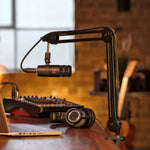 Adjustable microphone boom arm with black mic and cable, side view