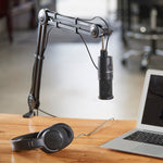 Adjustable boom arm with hanging microphone and desk base, black metal frame