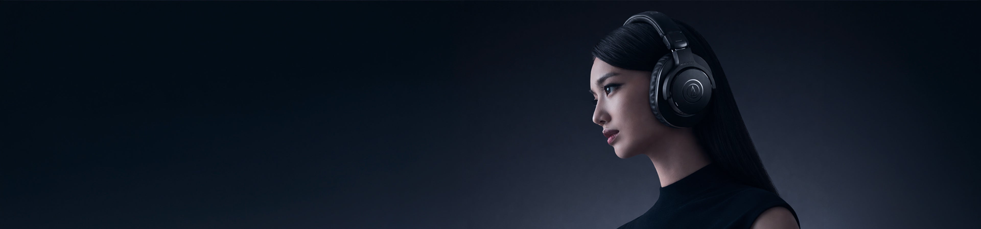 headphones price in pakistan Woman wearing a futuristic headset against a dark background