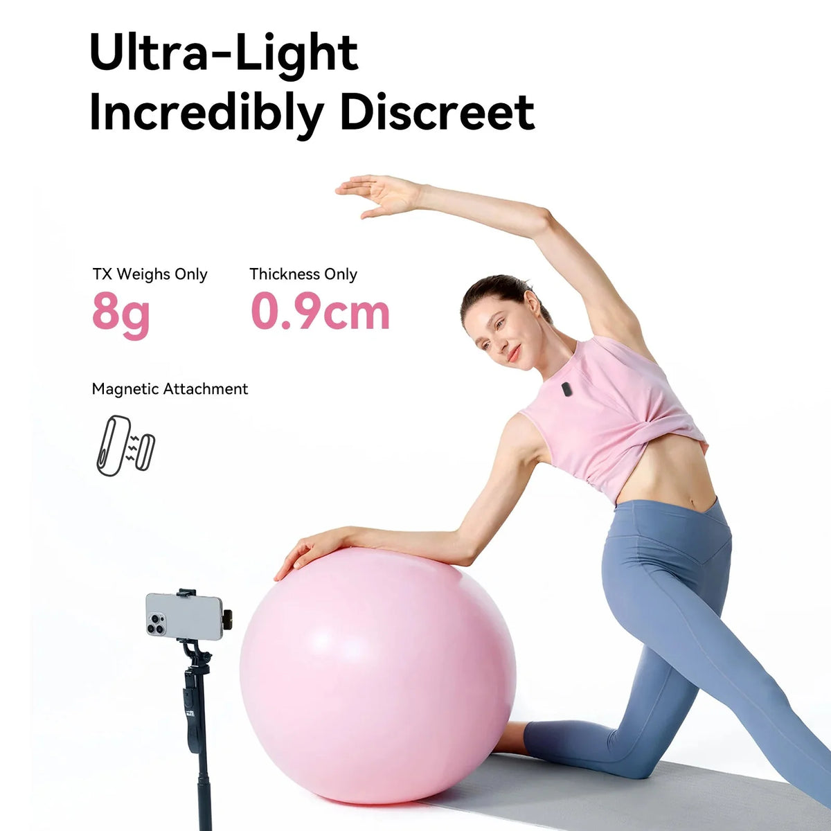 Wireless clip-on microphone with dark gray transmitter clipped on a pink shirt