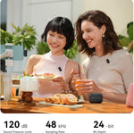Wireless clip-on microphones on two people, with compact receiver on tabletop
