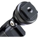 Close-up of black textured adjustment knob on a hot shoe phone clamp