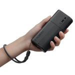 Hand holding a black power bank with 'Ulanzi FM02 FILMOG X Fog Machine' branding on a white background