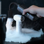 Hand holding a device emitting vapor over a surface with smoke Ulanzi FM02 FILMOG X Fog Machine