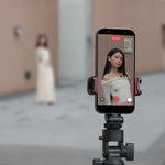 Wireless mini microphone mounted on a phone with a small black mic