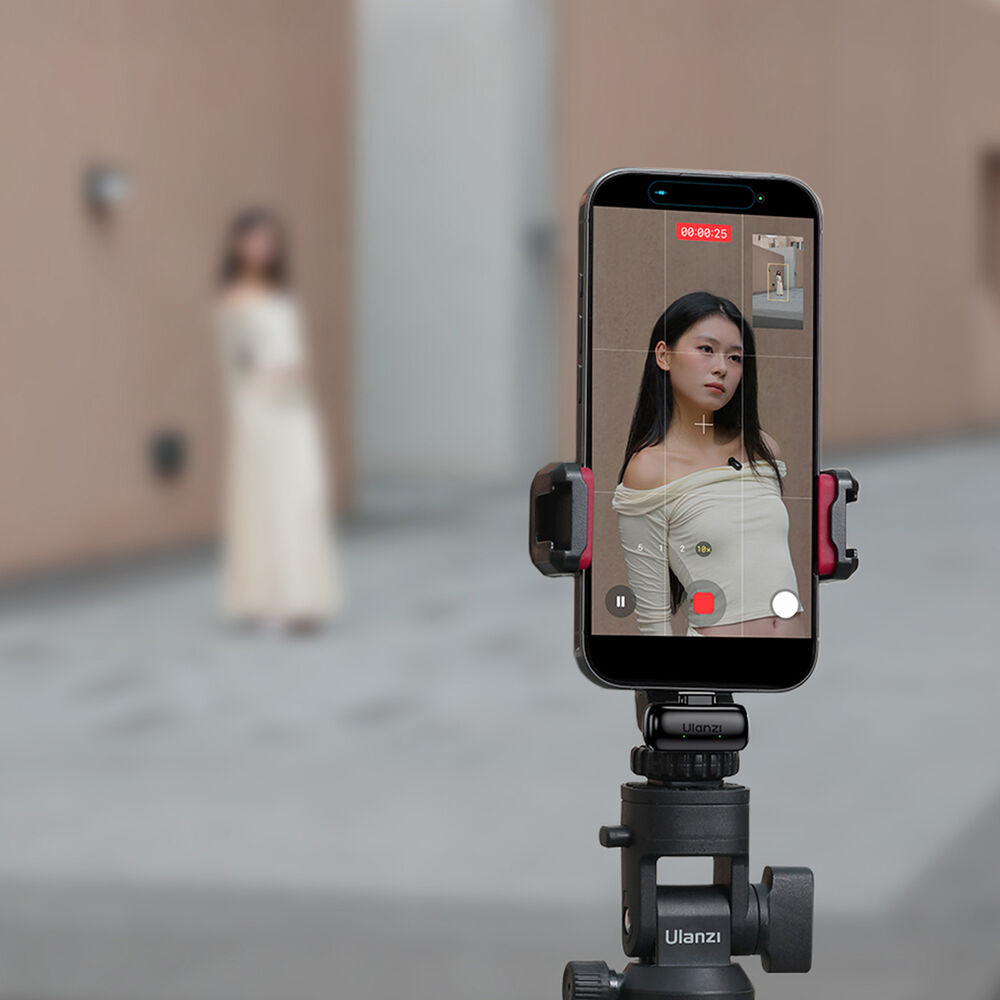 Wireless mini microphone mounted on a phone with a small black mic