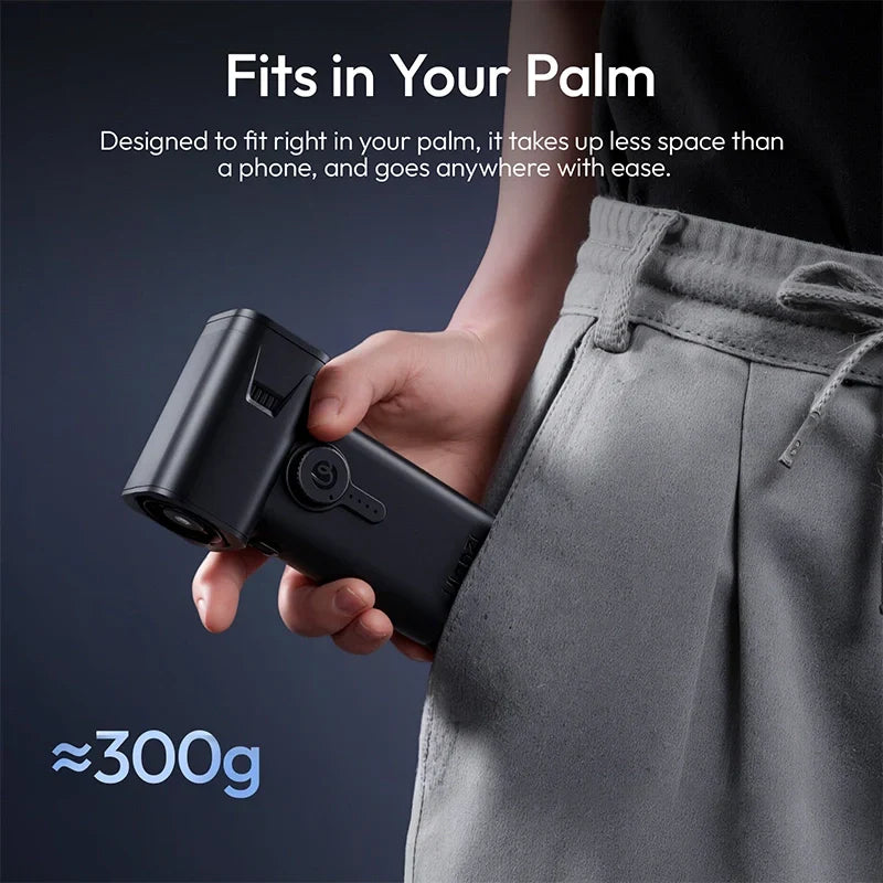 Compact electric air duster held in palm, black body and side controls