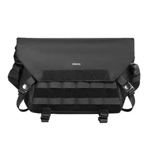Black sling bag with front flap, two buckled straps, and adjustable shoulder strap