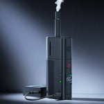 Black Ulanzi fog machine releasing a smoke plume from the top nozzle, standing with power cable.