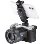 Black phone clamp mounted on a camera with cold shoe and smartphone holder