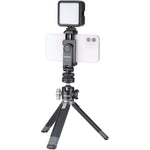 Black cold shoe phone clamp holding a phone with square light panel and tripod legs